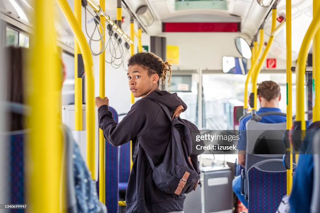Teenage boy commuting in bus