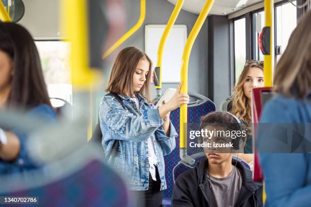 girl using smart phone in bus - bus front stock pictures, royalty-free photos & images