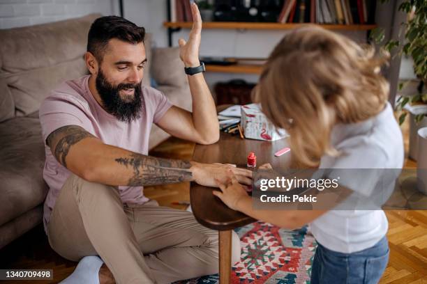 cute little girl paining his father nails - painting fingernails stock pictures, royalty-free photos & images