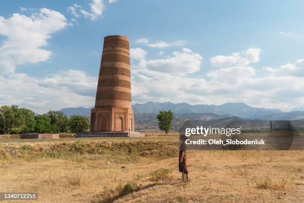 woman walking near  burana tower in kyrygzstan - bishkek imagens e fotografias de stock