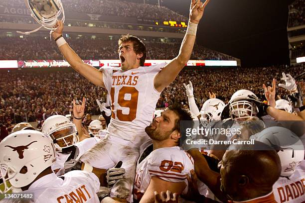 Justin Tucker of the Texas Longhorns celebrates with teammates after kicking the winning field goal as time expired in the second half of a game...