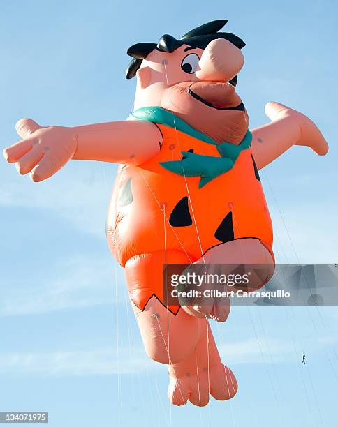 The Fred Flintstone balloon floats in the 92nd Annual 6ABC Dunkin' Donuts Thanksgiving Day Parade on November 24, 2011 in Philadelphia, Pennsylvania.