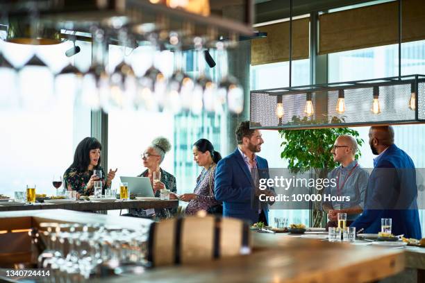 multi racial business colleagues at conference in hotel - comida de negocios fotografías e imágenes de stock