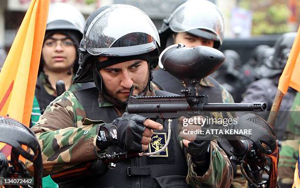 Members of Iran's paramilitary Basij militia show their skills during a parade in front of the former US embassy in Tehran on November 25, 2011 to...