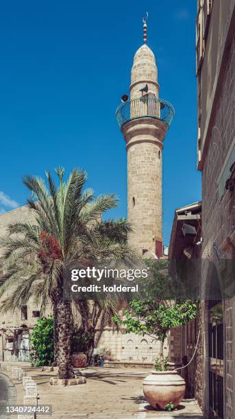 renovated mosque minaret against blue sky - minaret stockfoto's en -beelden