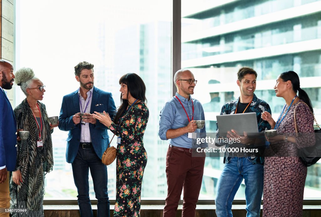 Multi racial business people at meet and greet in conference