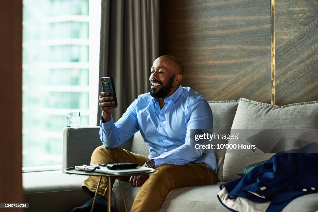 Mature black businessman calling kids on video call