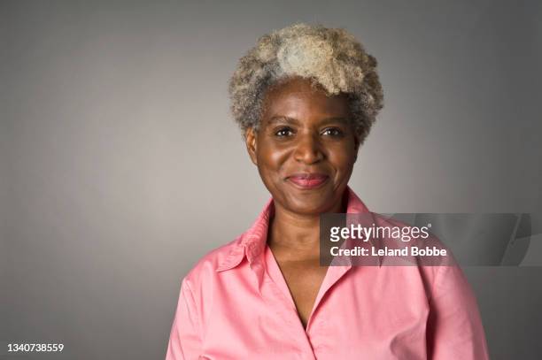 studio portrait of middle aged african american woman - portrait white hair studio stock pictures, royalty-free photos & images