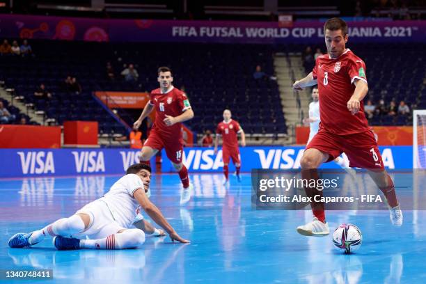 Mladen Kocic of Serbia shoots under pressure from Farhad Tavakoli of IR Iran during the FIFA Futsal World Cup 2021 group F match between Serbia and...