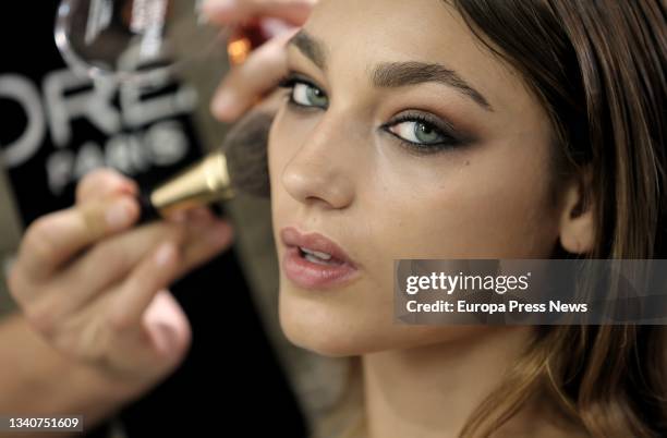 Make-up artist applies make-up to model Esther Rodriguez, backstage at the Duyos Spring/Summer 2022 collection show, on the day the catwalk of the...