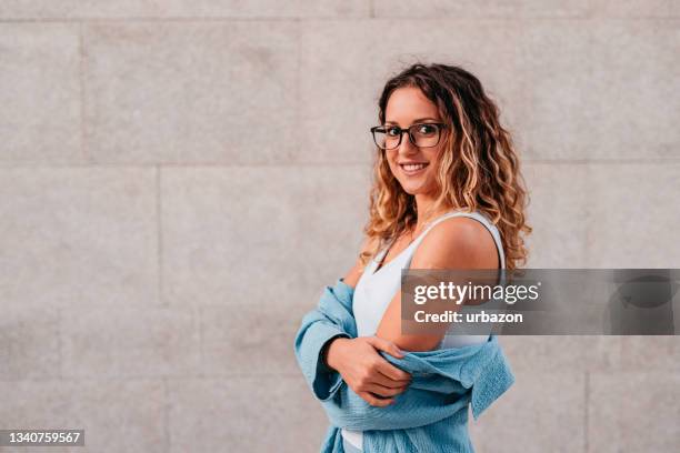 woman showing vaccinated arm with bandage after injection - young adult vaccine stock pictures, royalty-free photos & images