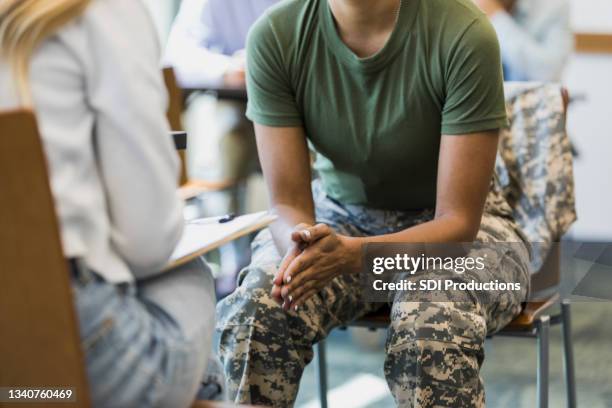 close up photo female soldier leaning forward in seat - military courage stock pictures, royalty-free photos & images