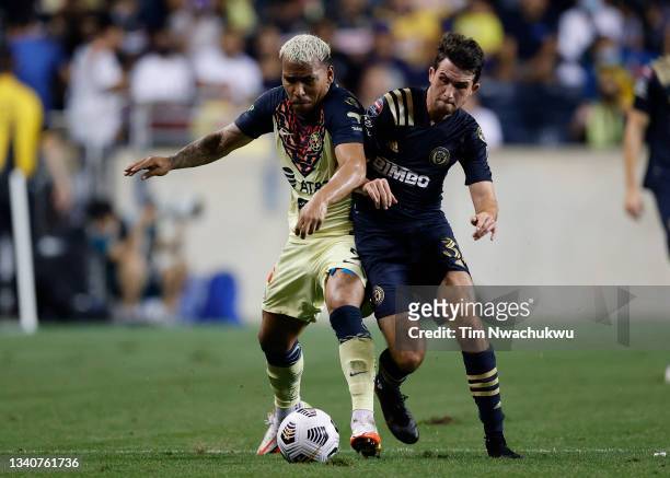 Roger Martínez of Club America and Leon Flach of Philadelphia Union challenge for possession during the semifinal second leg match of the CONCACAF...