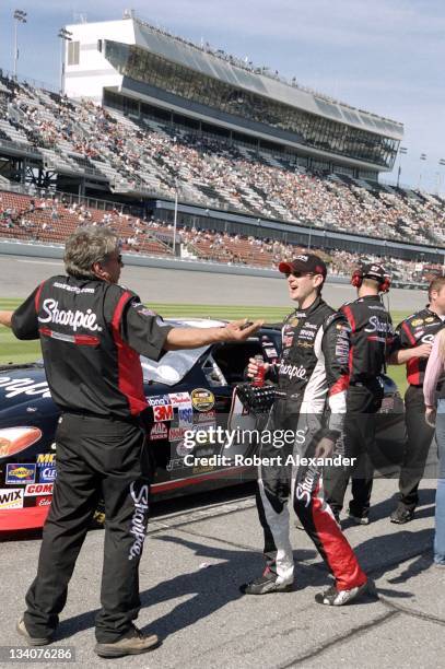 Driver Kurt Busch jokes with a member of his racing crew prior to making his 2005 Daytona 500 qualifying run at the Daytona International Speedway on...