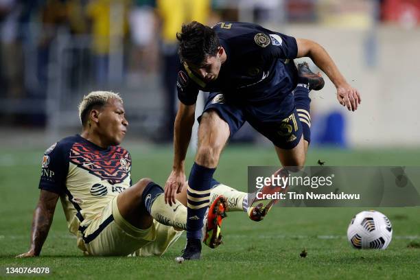 Roger Martínez of Club America and Leon Flach of Philadelphia Union challenge for possession during the semifinal second leg match of the CONCACAF...