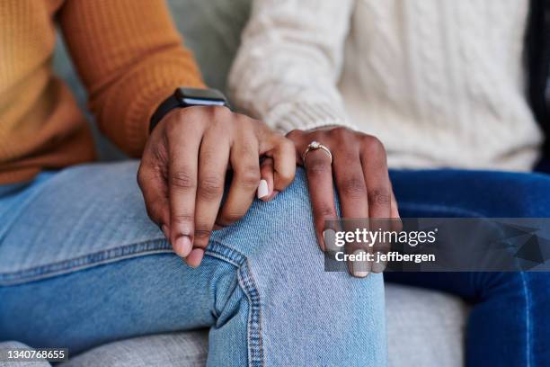 closeup shot of an unrecognisable couple holding hands while relaxing together at home - little finger stock pictures, royalty-free photos & images