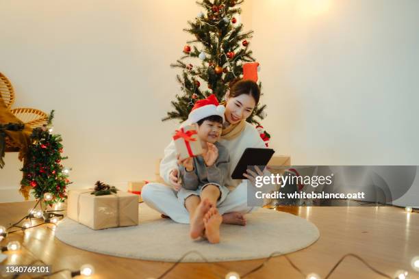 mother and son making a video conference at christmas time - quarantine christmas stock pictures, royalty-free photos & images