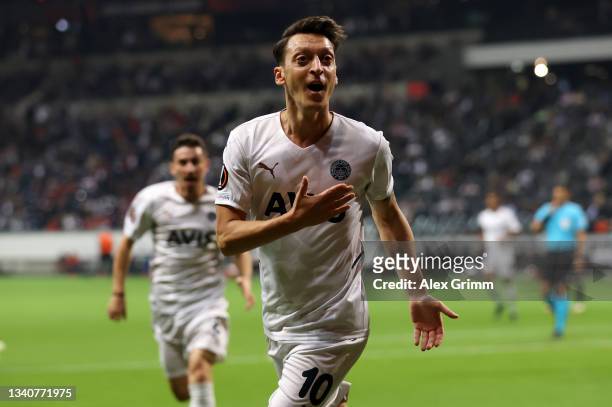 Mesut Ozil of Fenerbahce celebrates after scoring their side's first goal during the UEFA Europa League group D match between Eintracht Frankfurt and...