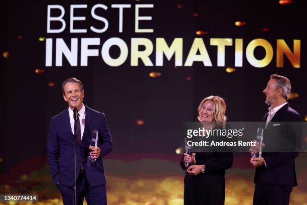 Markus Heidemanns, Markus Lanz and Susanne Krummacher receive the "Beste Information" award on stage during the German Television Award at...
