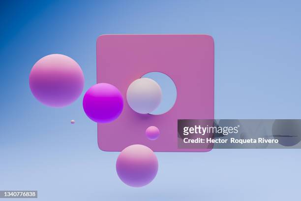 three dimensional spheres hitting holes, blue background - harmony fotografías e imágenes de stock