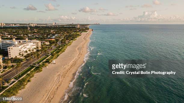 aerial drone views of ocean waves sweeping across the palm beach, florida seashore at sunrise in september of 2021 - palm beach florida stock pictures, royalty-free photos & images