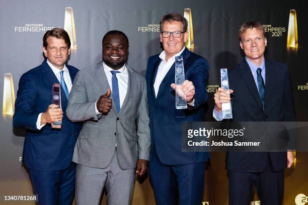 Leopold Hoesch, Gerald Asamoah, Thomas Fuhrmann and Gerrit Roth pose with the "Beste Dokumentation/Reportage" award during the German Television...