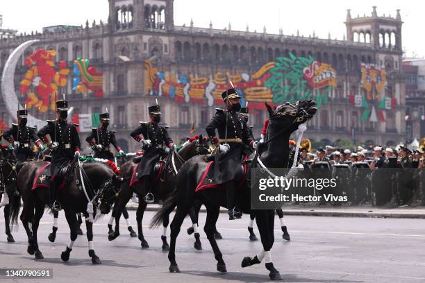 Mexican army horse riders march during the annual shout of independence as part of the independence day celebrations on September 16, 2021 in Mexico...