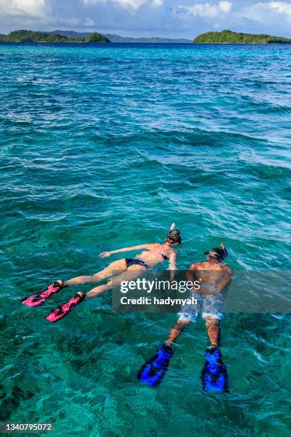 young couple snorkeling on east china sea, philippines - cebu province stock pictures, royalty-free photos & images