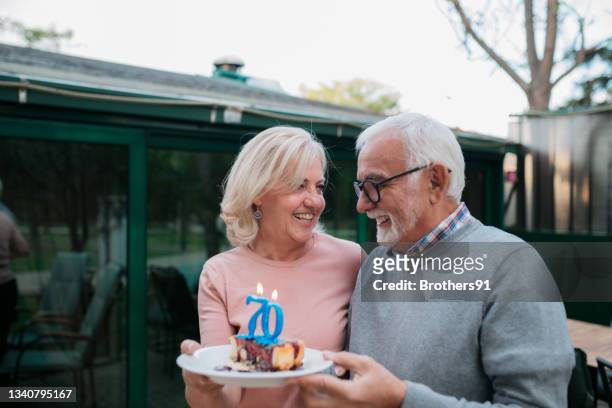 happy senior caucasian couple celebrating birthday together - wife birthday stock pictures, royalty-free photos & images