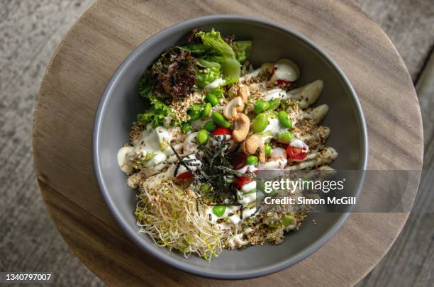 poke bowl with quinoa, cashew nuts, edamame, lettuce, alfalfa sprouts, cherry tomatoes, nori and yuzu mayonnaise - yuzu stock pictures, royalty-free photos & images