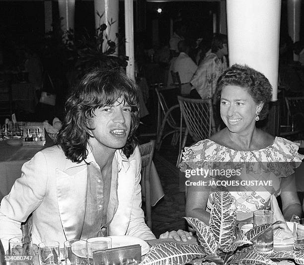 Princess Margaret, the younger sister of Britain's Queen Elizabeth II, chats 08 December 1976 in a restaurant in Pointe-du-Bout, French West Indies,...