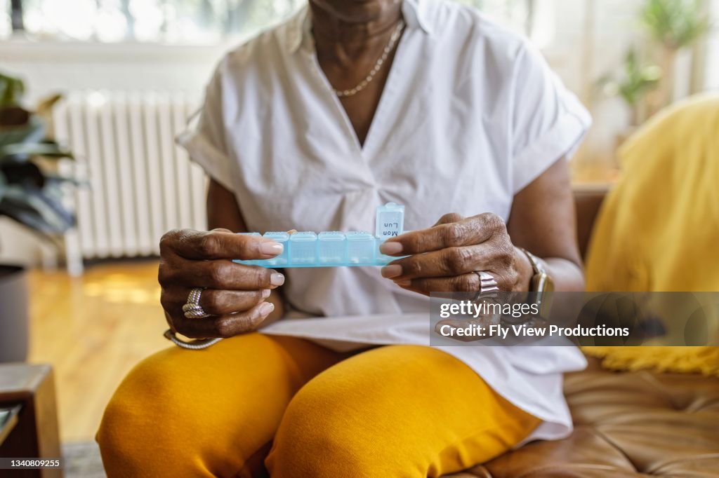 Woman taking daily dosage of medicines