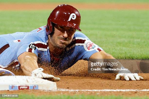 Matt Joyce of the Philadelphia Phillies slides to third base during the fourth inning against the Chicago Cubs at Citizens Bank Park on September 16,...