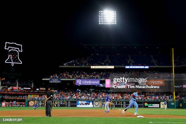 Bryce Harper of the Philadelphia Phillies rounds bases after hitting a three run home run during the seventh inning against the Chicago Cubs at...