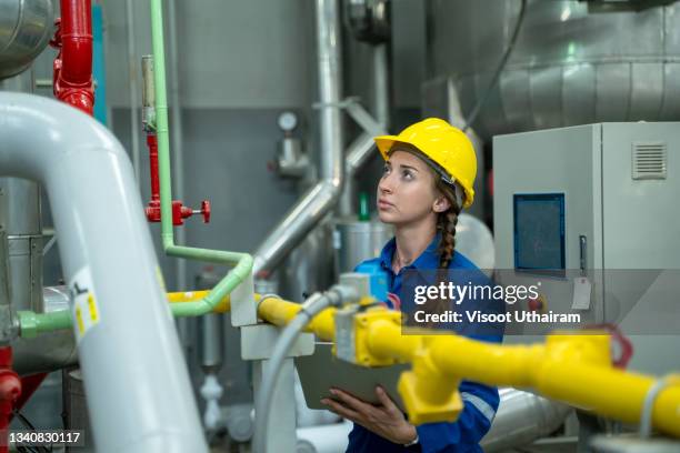 industry engineer women checking and inspection of heating system on pressure gauge of industrial air compressor system at industrial factory. - escarpin à talon photos et images de collection