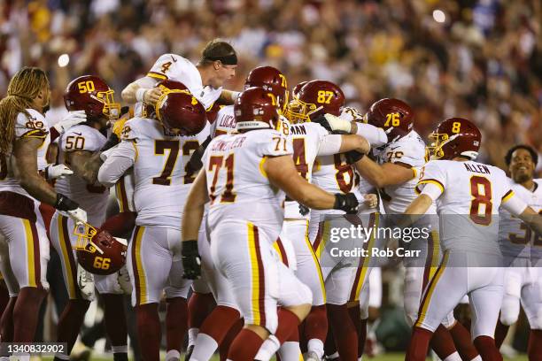 Taylor Heinicke and the Washington Football Team celebrate a 30-29 win over the New York Giants at FedExField on September 16, 2021 in Landover,...