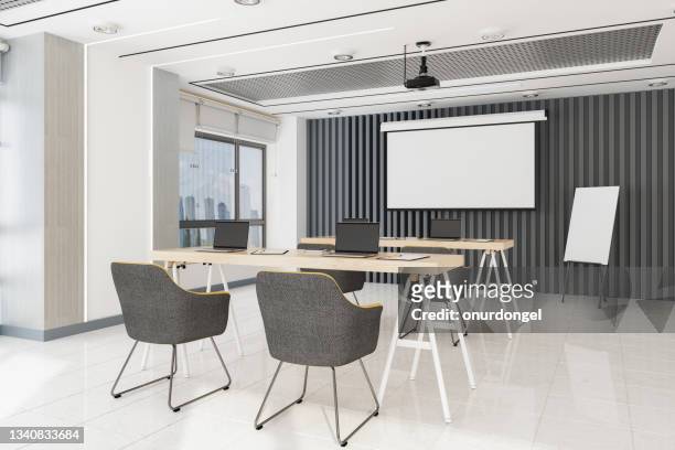 modern office seminar room with projection equipment, whiteboard, tables, laptops and chairs - social distancing classroom stockfoto's en -beelden
