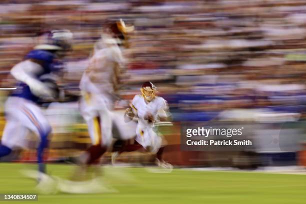 Taylor Heinicke of the Washington Football Team scrambles with the ball during the fourth quarter against the New York Giants at FedExField on...