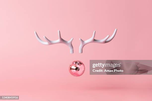 christmas reindeer concept on pink background made horns and xmas party ball on pastel pink background. minimal winter vacation idea. - caribou stock pictures, royalty-free photos & images