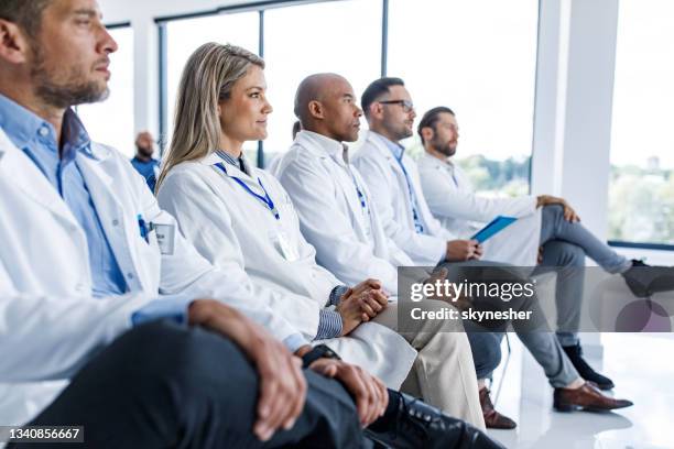 medizinische experten, die an einer bildungsveranstaltung im boardroom teilnehmen. - konferenz stock-fotos und bilder