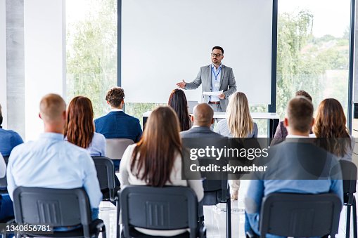 Business leader giving a speech on a seminar in board room. Business leader giving a speech on a seminar in board room.