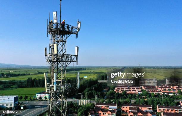 Workers of China Mobile set up 5G antennas on a tower on September 16, 2021 in Tongling, Anhui Province of China.