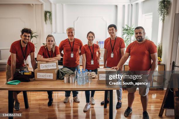 group of volunteers at the donation center - benefits stock pictures, royalty-free photos & images