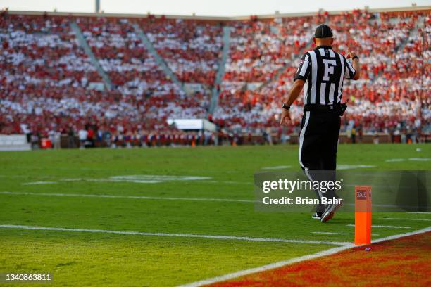 Field judge Patrick Herron signals to the Western Carolina Catamounts during a break in play during the first quarter against the Oklahoma Sooners at...