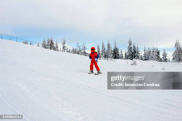 little girl on the ski slope, beautiful day in vacation, winter sports, sky background,hiking. - alps romania stock pictures, royalty-free photos & images