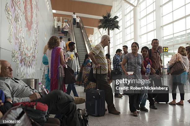 Indian and foreign passengers wait for their flight to Goa October 11, 2011 in the domestic terminal of the Indira Gandhi International Airport in...