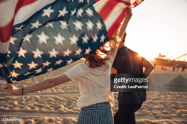 beautiful young couple by the beach - city of los angeles flag stock pictures, royalty-free photos & images