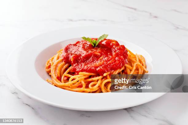 spaghetti with tomato sauce on white background. - sauce stock pictures, royalty-free photos & images