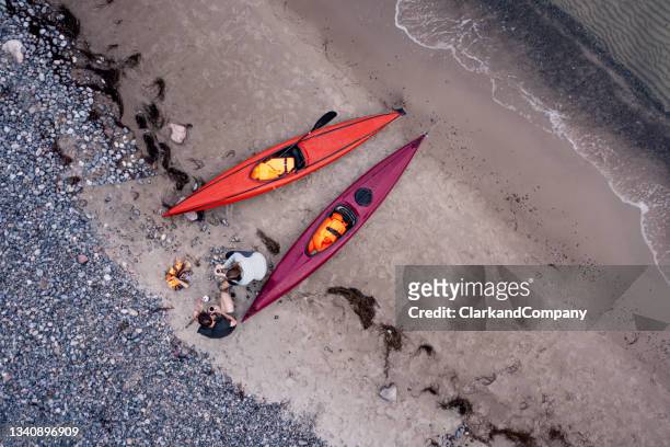 couple relaxing after kayak trip - zealand denmark stock pictures, royalty-free photos & images