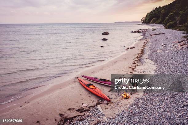 couple relaxing after kayak trip - sea kayak stock pictures, royalty-free photos & images